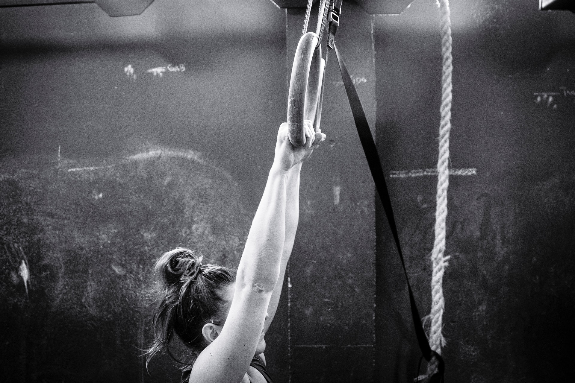 woman gymnastics in white tank top raising her hands photo